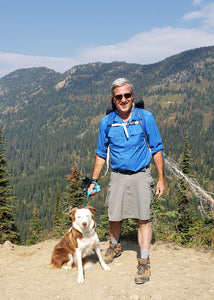 Man wearing hiking skirt while out hiking with his dog.
