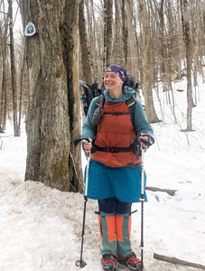 Woman wearing hiking skirt with leggings and winter clothes while out on the Appalachian Trail in the snow.